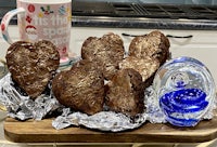 chocolate heart shaped brownies on a tray with a cup of coffee