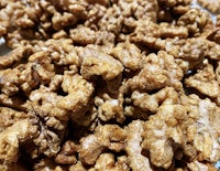 a pile of walnuts on a white plate