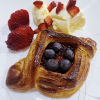 a pastry with berries and ice cream on a plate