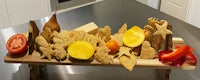 a wooden tray with fruit and vegetables on it