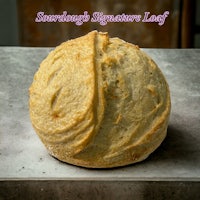 a loaf of bread with the words sourdough signature leaf