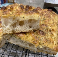 a piece of bread is sitting on a cooling rack