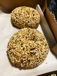 two bagels with sesame seeds in a box